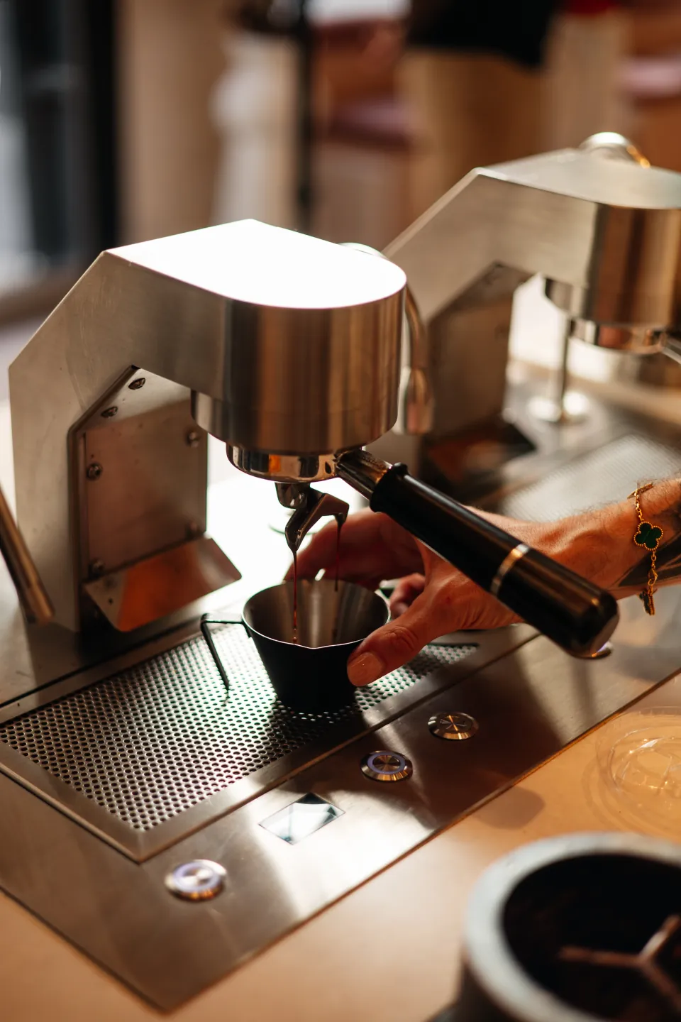 A barista pulling a fresh espresso shot
